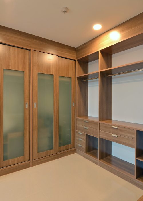 wooden carbinets in dressing room in modern home, interior design