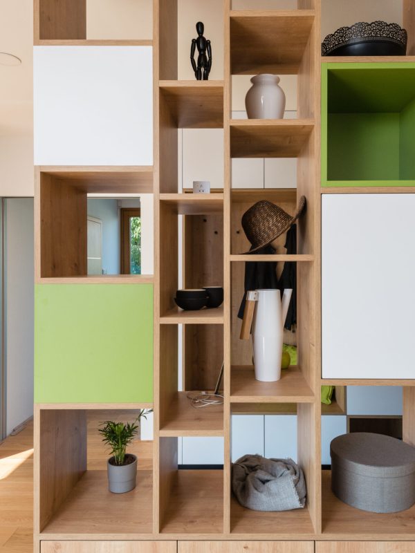 Custom made colorful wooden shelves in the hall of modern house